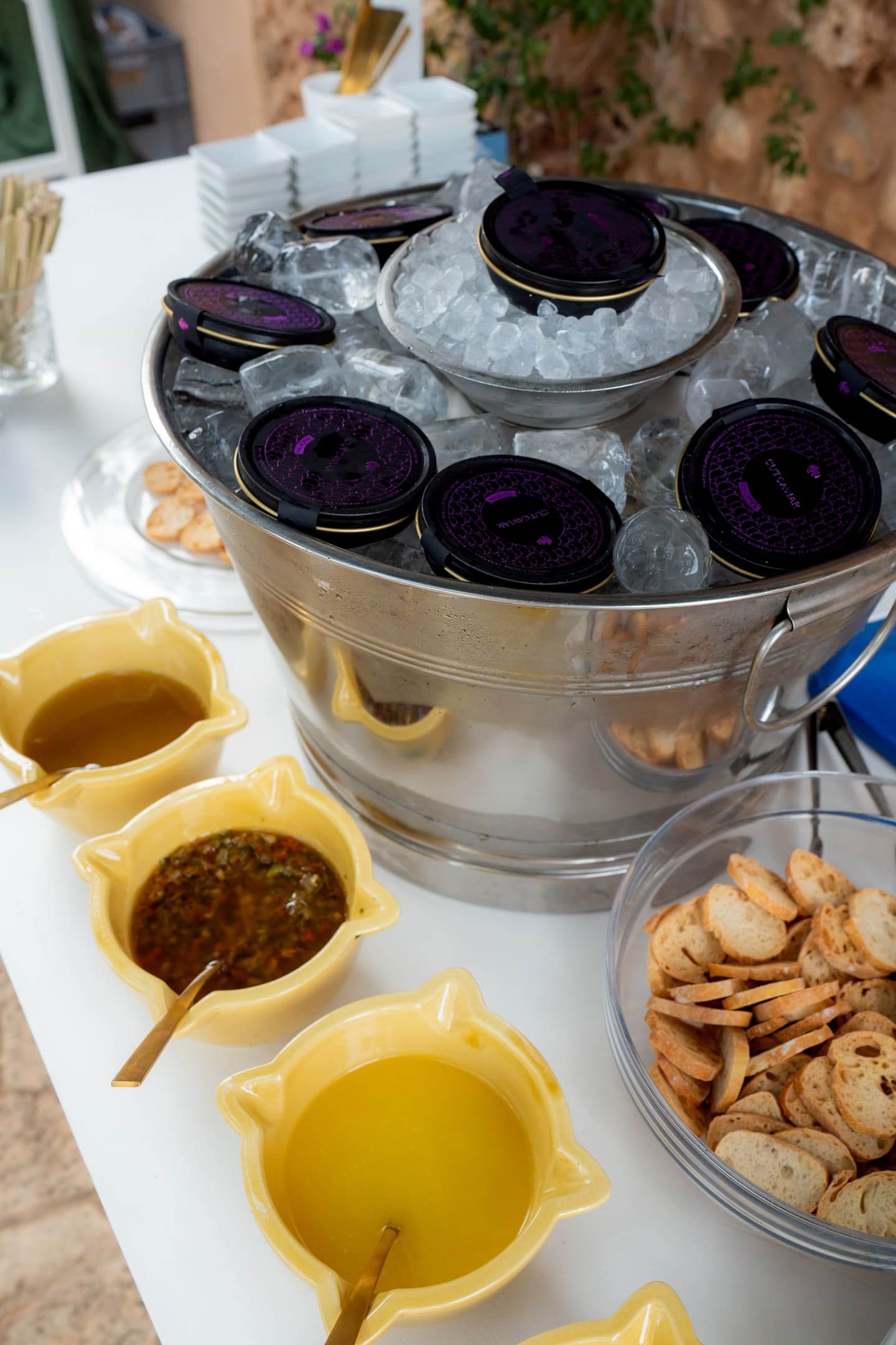 Tins of caviar on ice with warm blinis and sauces