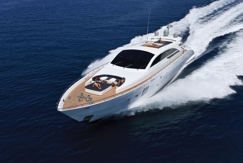 A motor yacht cutting through deep blue water at speed